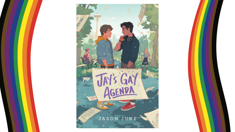 the cover of "Jay's GAY Agenda" by Jason June, showing an illustration of two teen guys staring into each other's eyes with the Seattle space needle in the background. The cover is flanked by the wavy diversity rainbow pride flags.